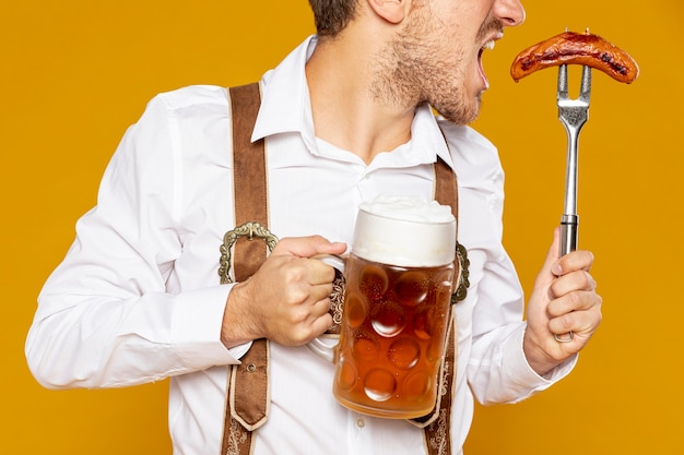 Medium shot of man holding beer pint